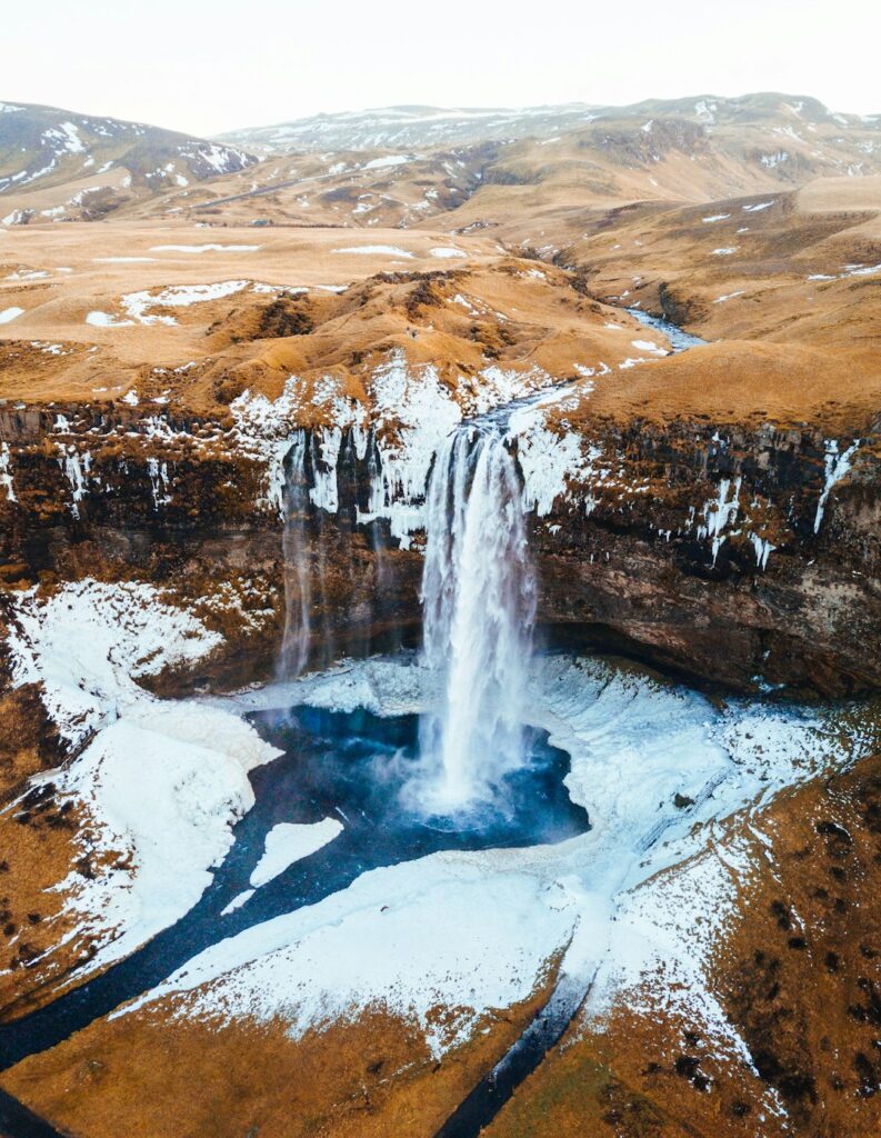 aerial-photography-of-waterfalls-near-mountains-at-daytime-36k5wckeu3o